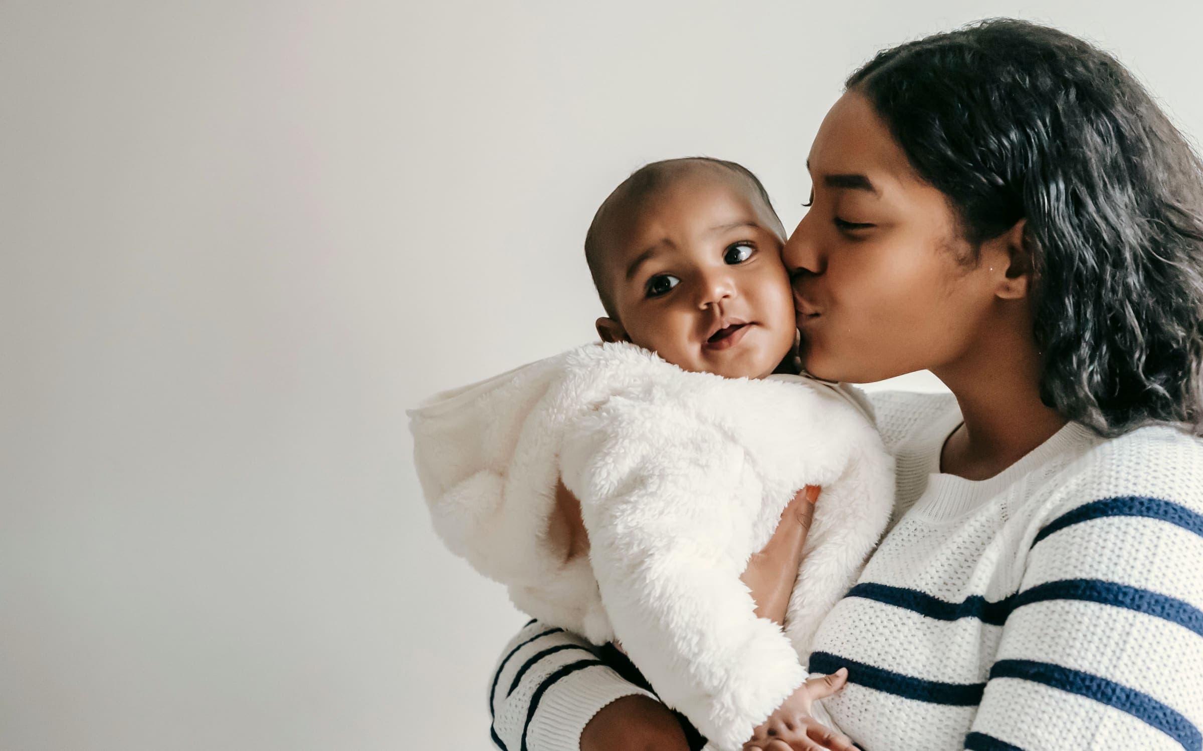 A mother holding her baby close